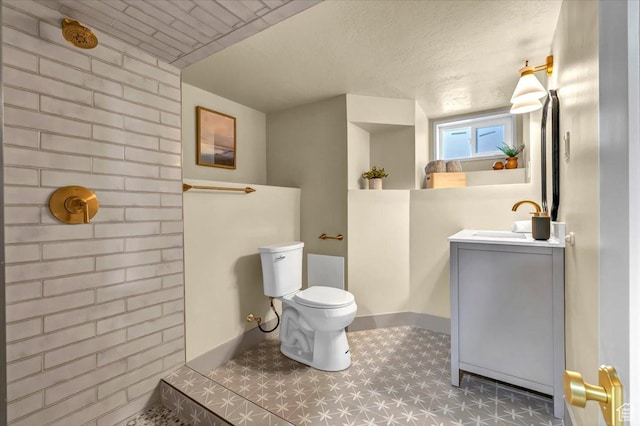 1444 E Sherman Ave, Salt Lake City, UT 84105 - bathroom featuring a tile shower, toilet, vanity, a textured ceiling, and brick wall