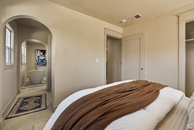 1444 E Sherman Ave, Salt Lake City, UT 84105 - carpeted bedroom with arched walkways, baseboards, and visible vents