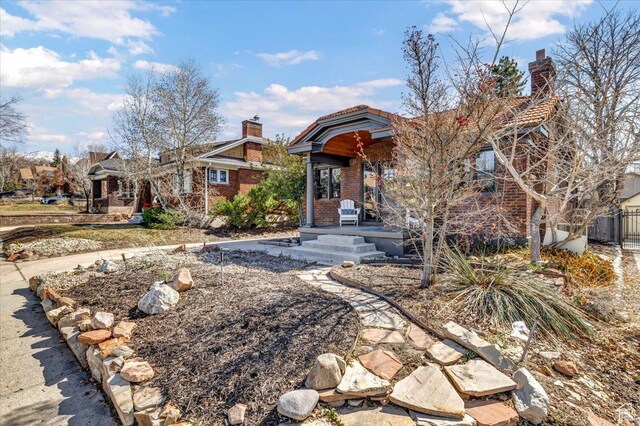 1444 E Sherman Ave, Salt Lake City, UT 84105 - view of front of home with a tiled roof, brick siding, and a chimney