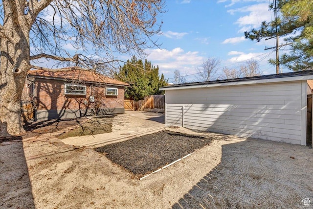 1444 E Sherman Ave, Salt Lake City, UT 84105 - view of yard featuring an outbuilding, fence, and a patio area