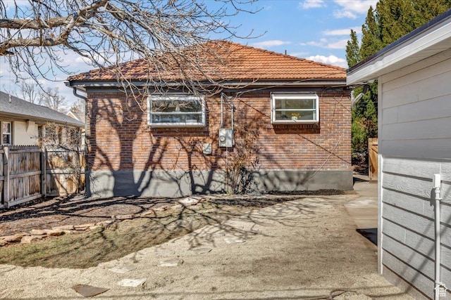 1444 E Sherman Ave, Salt Lake City, UT 84105 - view of home's exterior featuring a tile roof and fence