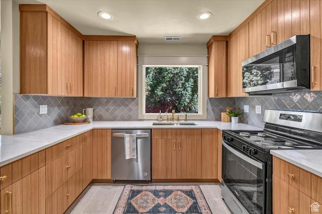 1444 E Sherman Ave, Salt Lake City, UT 84105 - kitchen featuring a sink, light tile patterned flooring, visible vents, light stone countertops, and appliances with stainless steel finishes