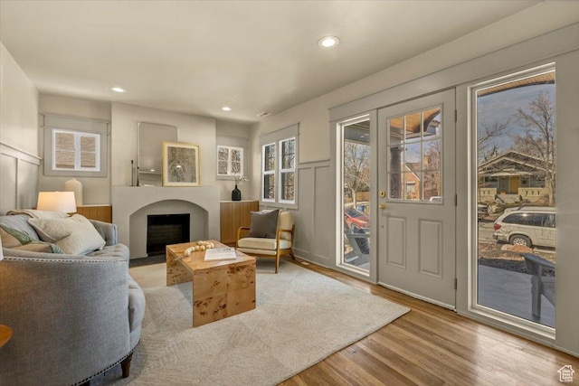 1444 E Sherman Ave, Salt Lake City, UT 84105 - living area featuring wood finished floors, recessed lighting, a decorative wall, a fireplace, and wainscoting