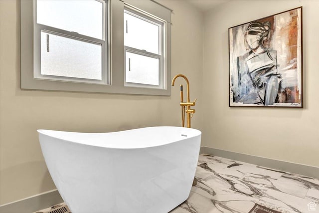 1444 E Sherman Ave, Salt Lake City, UT 84105 - bathroom with baseboards, marble finish floor, and a soaking tub