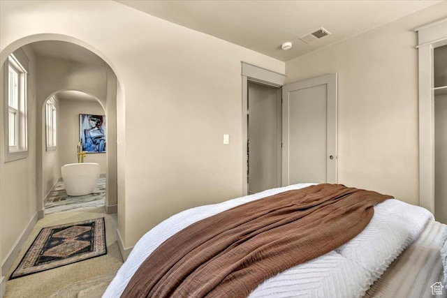 1444 E Sherman Ave, Salt Lake City, UT 84105 - carpeted bedroom with arched walkways, baseboards, and visible vents