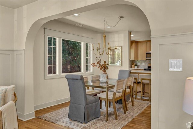 1444 E Sherman Ave, Salt Lake City, UT 84105 - dining space with arched walkways, visible vents, recessed lighting, and light wood finished floors