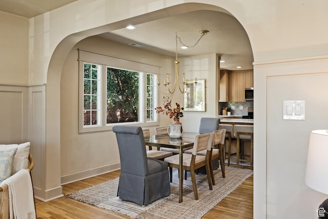 1444 E Sherman Ave, Salt Lake City, UT 84105 - dining area featuring arched walkways, visible vents, recessed lighting, and light wood-type flooring