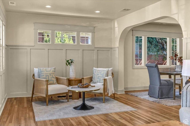 1444 E Sherman Ave, Salt Lake City, UT 84105 - sitting room with a wealth of natural light, wood finished floors, and arched walkways