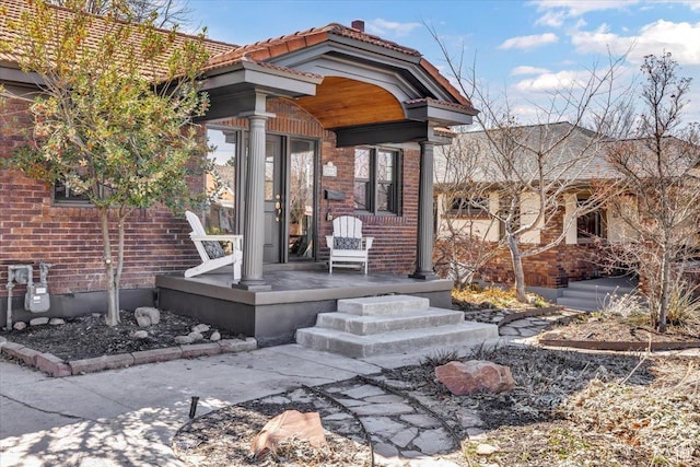 1444 E Sherman Ave, Salt Lake City, UT 84105 - view of exterior entry featuring brick siding and a porch