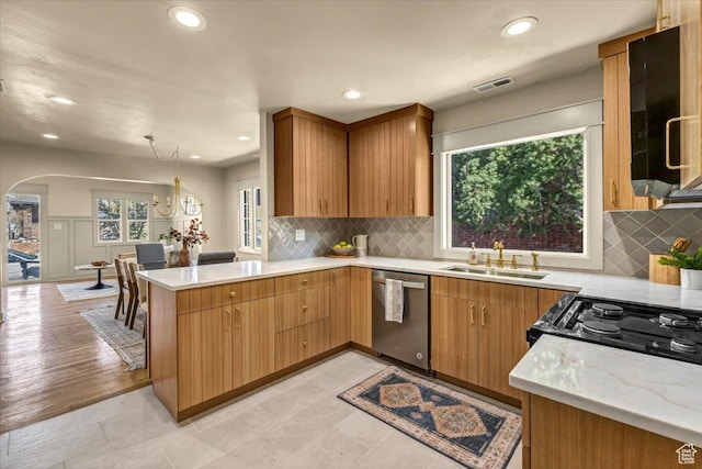 1444 E Sherman Ave, Salt Lake City, UT 84105 - kitchen with stainless steel dishwasher, a sink, arched walkways, visible vents, and a peninsula