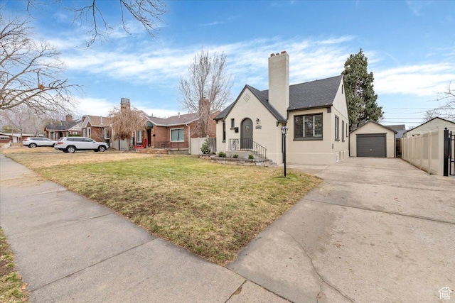 1662 E Browning Ave, Salt Lake City, UT 84105 - view of front of home featuring a front yard, fence, an outdoor structure, concrete driveway, and a detached garage