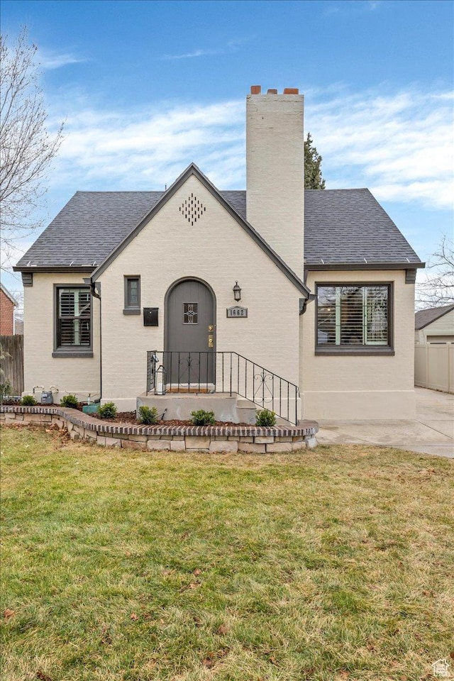 1662 E Browning Ave, Salt Lake City, UT 84105 - view of front facade with brick siding, a chimney, a front lawn, and fence