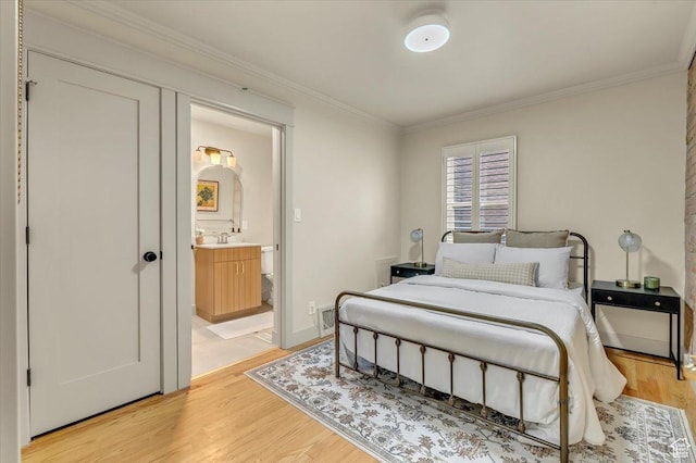 1662 E Browning Ave, Salt Lake City, UT 84105 - bedroom featuring baseboards, a sink, ornamental molding, ensuite bathroom, and light wood-type flooring