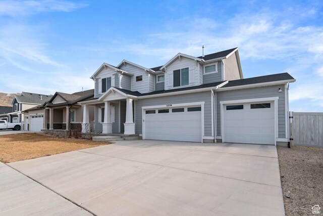 2256 E Emerald Ave Unit 208, Eagle Mountain, UT 84005 - view of front of house with a porch, fence, a garage, and driveway