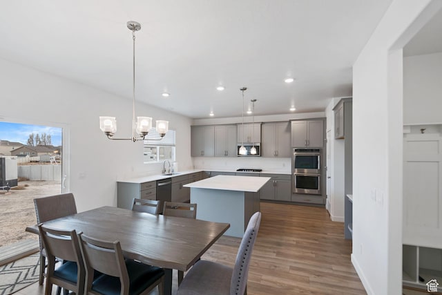2256 E Emerald Ave Unit 208, Eagle Mountain, UT 84005 - dining area with a notable chandelier, recessed lighting, wood finished floors, and baseboards