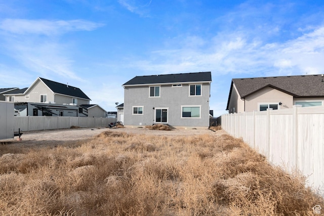 2256 E Emerald Ave Unit 208, Eagle Mountain, UT 84005 - rear view of house featuring stucco siding and fence