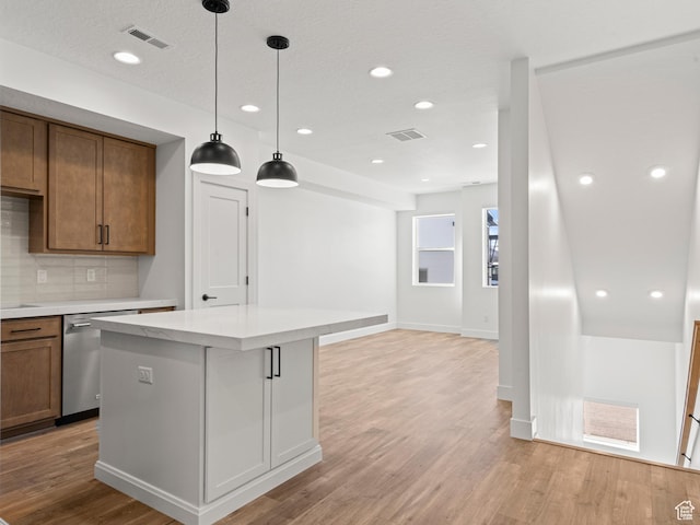 1151 Gambel Oak Way Unit 54, Park City, UT 84098 - kitchen featuring visible vents, a kitchen island, dishwasher, light wood-type flooring, and backsplash