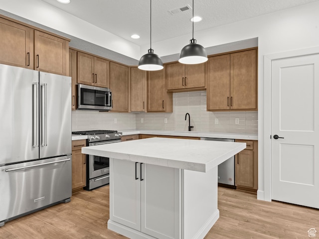 1151 Gambel Oak Way Unit 54, Park City, UT 84098 - kitchen featuring light wood-type flooring, visible vents, appliances with stainless steel finishes, and brown cabinetry