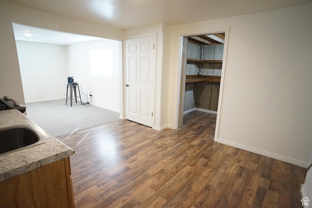 6835 S Larabrook Way, West Jordan, UT 84084 - interior space featuring baseboards, a sink, and dark wood-type flooring
