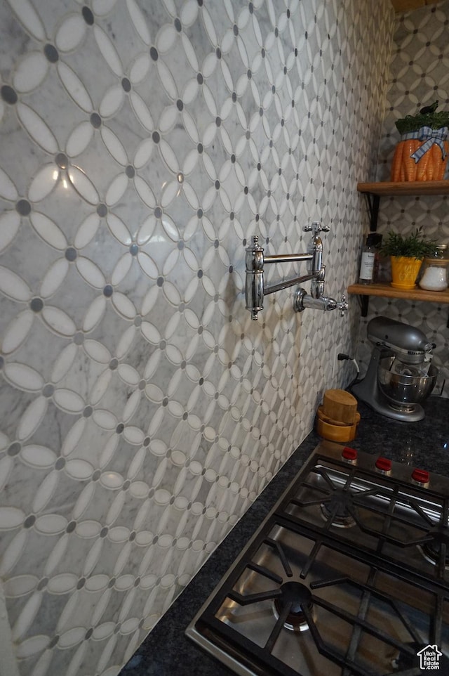 6835 S Larabrook Way, West Jordan, UT 84084 - room details with stainless steel gas cooktop, wallpapered walls, and dark countertops