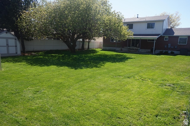 6835 S Larabrook Way, West Jordan, UT 84084 - view of yard featuring a storage shed, fence, and an outbuilding