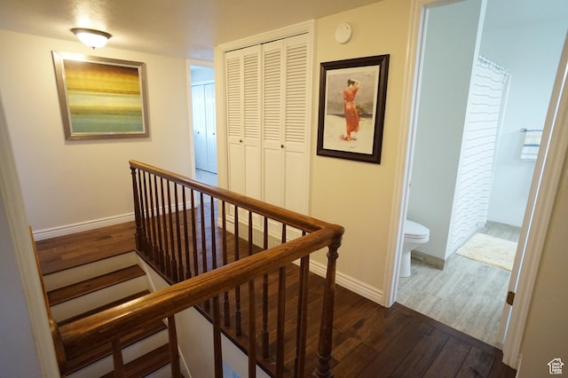 6835 S Larabrook Way, West Jordan, UT 84084 - hallway featuring baseboards, dark wood-style flooring, and an upstairs landing
