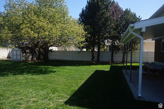 6835 S Larabrook Way, West Jordan, UT 84084 - view of yard with fence, an outbuilding, a patio area, and a shed