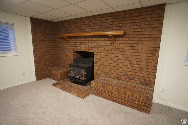 6835 S Larabrook Way, West Jordan, UT 84084 - unfurnished living room with carpet flooring, baseboards, a drop ceiling, and a wood stove