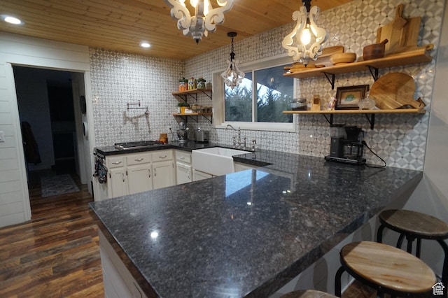 6835 S Larabrook Way, West Jordan, UT 84084 - kitchen with open shelves, dark wood-style flooring, a peninsula, tasteful backsplash, and a sink