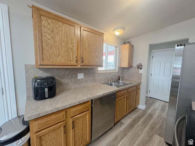 1993 W 4200 S, Roy, UT 84067 - kitchen featuring tasteful backsplash, light countertops, light wood-style flooring, stainless steel appliances, and a sink