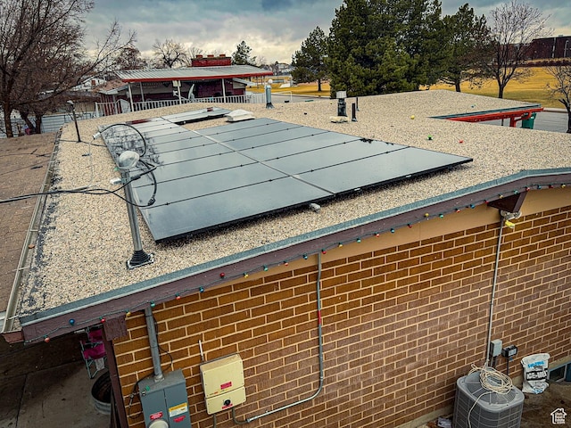 1993 W 4200 S, Roy, UT 84067 - details with a flat roof, brick siding, central AC, and electric meter