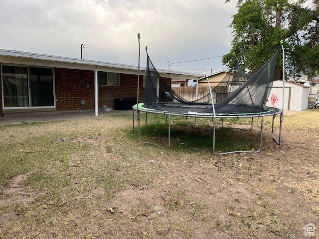 1993 W 4200 S, Roy, UT 84067 - view of yard featuring a trampoline and a storage unit