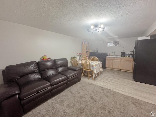 1993 W 4200 S, Roy, UT 84067 - living room featuring a textured ceiling, light wood-type flooring, and a chandelier