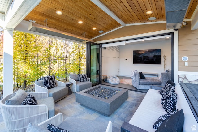 view of patio / terrace with an outdoor living space with a fire pit