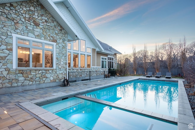 view of pool featuring a patio area, a fenced in pool, and fence