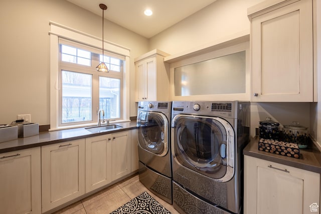 washroom featuring a sink, washer and dryer, recessed lighting, cabinet space, and light tile patterned floors