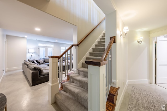 stairs featuring recessed lighting, baseboards, and finished concrete flooring