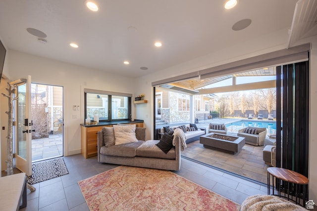 tiled living area featuring recessed lighting and a healthy amount of sunlight