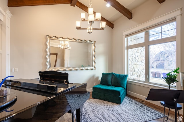 office space with baseboards, lofted ceiling with beams, an inviting chandelier, and wood finished floors
