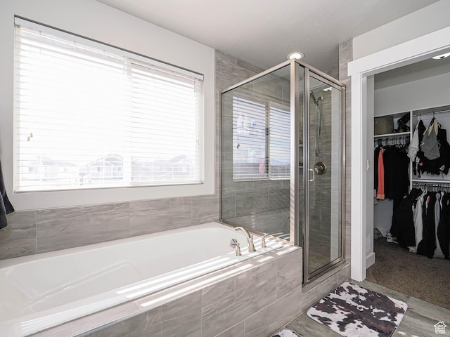 3765 E Cunninghill Dr, Eagle Mountain, UT 84005 - bathroom with a wealth of natural light, a garden tub, a stall shower, and a spacious closet