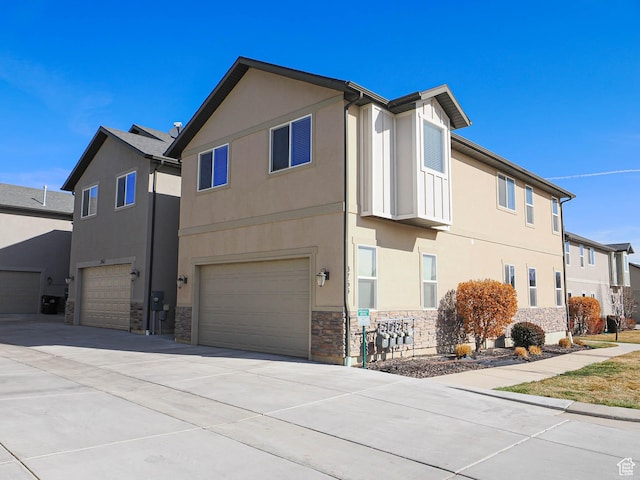 3765 E Cunninghill Dr, Eagle Mountain, UT 84005 - view of front of property featuring stucco siding, driveway, stone siding, a residential view, and an attached garage