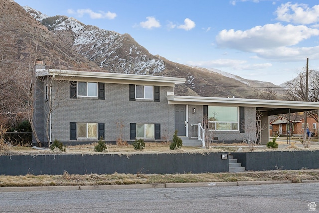 118 N Iowa Ave, Ogden, UT 84404 - split level home with brick siding, a mountain view, and a chimney