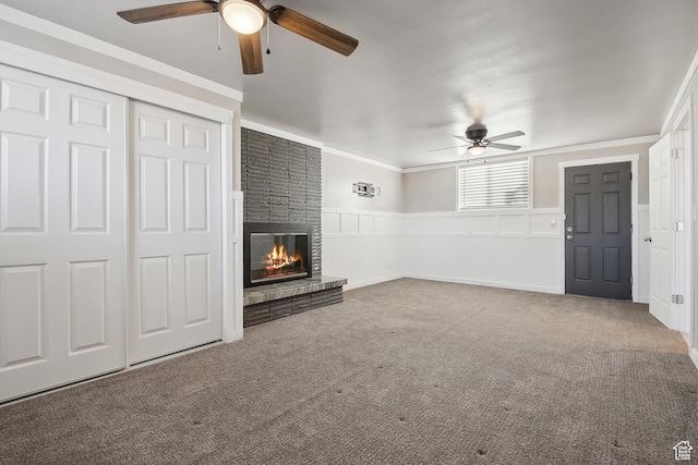 118 N Iowa Ave, Ogden, UT 84404 - unfurnished living room with a brick fireplace, wainscoting, carpet flooring, and crown molding