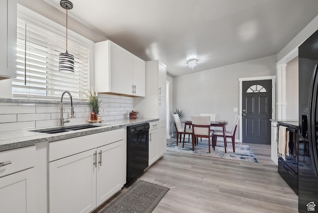 118 N Iowa Ave, Ogden, UT 84404 - kitchen featuring a sink, black appliances, light wood-style floors, white cabinetry, and tasteful backsplash