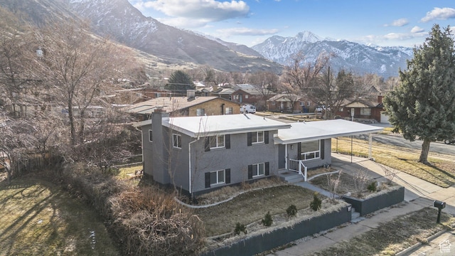 118 N Iowa Ave, Ogden, UT 84404 - exterior space featuring a chimney, an attached carport, a mountain view, and concrete driveway