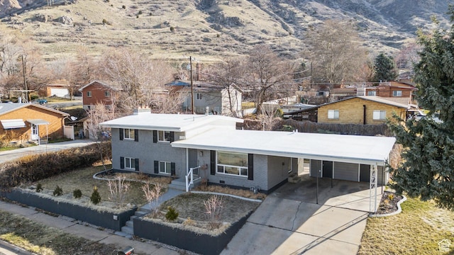 118 N Iowa Ave, Ogden, UT 84404 - view of front of house featuring a mountain view, a residential view, concrete driveway, a carport, and a chimney
