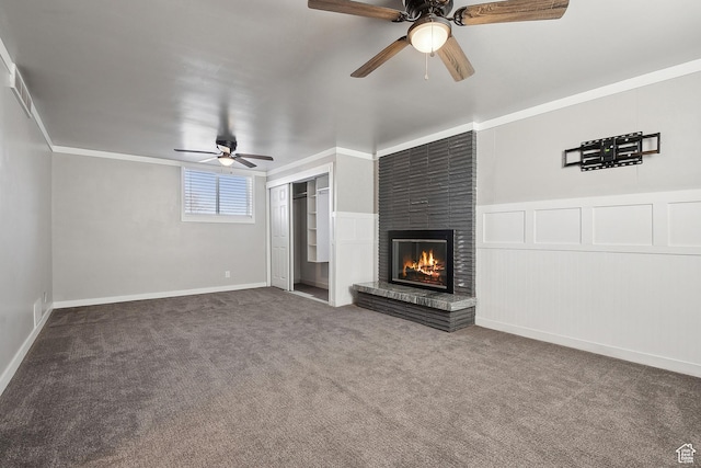 118 N Iowa Ave, Ogden, UT 84404 - unfurnished living room featuring a ceiling fan, carpet floors, ornamental molding, a brick fireplace, and a decorative wall
