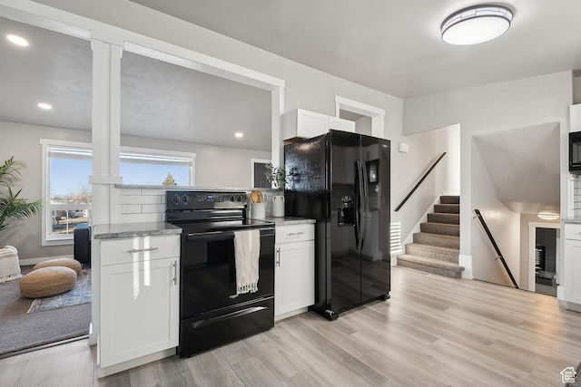 118 N Iowa Ave, Ogden, UT 84404 - kitchen featuring black appliances, white cabinets, light stone countertops, and light wood finished floors
