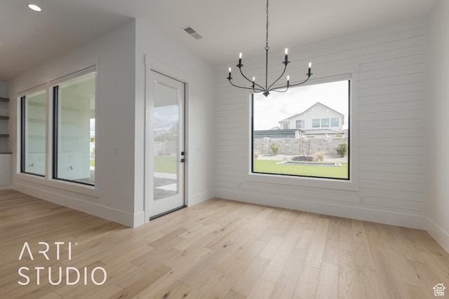 3823 S Kennedy Ln, Washington, UT 84780 - unfurnished dining area with visible vents, a notable chandelier, a healthy amount of sunlight, and wood finished floors
