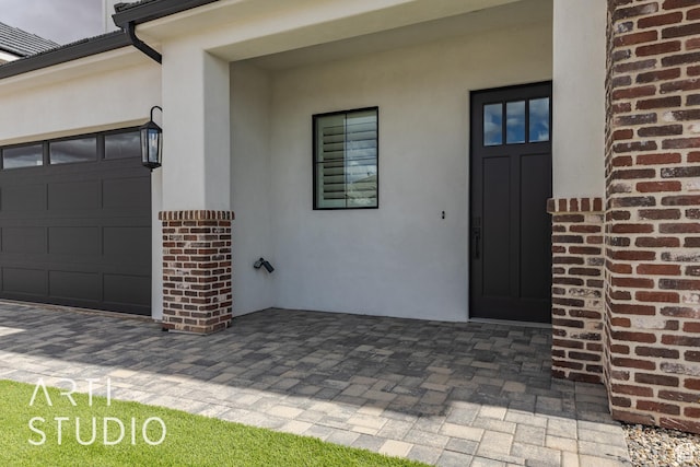 3823 S Kennedy Ln, Washington, UT 84780 - doorway to property with brick siding, stucco siding, driveway, and a garage